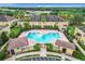 Community pool with surrounding patio and cabanas at 519 Sandstone St, Lakeland, FL 33809
