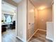 A light hallway with laminate flooring, showing access to an office and a bedroom at 519 Sandstone St, Lakeland, FL 33809