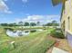 Landscaped backyard with pond view and lush green grass at 519 Sandstone St, Lakeland, FL 33809