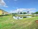 Serene backyard view of a pond, green space, and townhouses at 519 Sandstone St, Lakeland, FL 33809