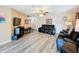 Living room with a view into kitchen, hardwood floors and black leather furniture at 519 Sandstone St, Lakeland, FL 33809