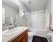 Clean bathroom with tub shower and wood vanity at 519 Sandstone St, Lakeland, FL 33809