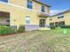 Private backyard with grassy area and adjacent building at 519 Sandstone St, Lakeland, FL 33809