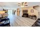 Spacious living room with hardwood floors, comfortable seating, and a fireplace at 519 Sandstone St, Lakeland, FL 33809