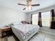 Bright bedroom featuring a king-size bed, ceiling fan, and wood-look floors at 519 Sandstone St, Lakeland, FL 33809