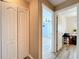 Hallway with light walls and laminate wood flooring, showing access to bedrooms and closets at 519 Sandstone St, Lakeland, FL 33809