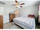 King-size bed in a spacious bedroom with ceiling fan and dresser at 519 Sandstone St, Lakeland, FL 33809
