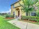 Well-maintained townhome with landscaping, a walkway, and a charming entrance at 519 Sandstone St, Lakeland, FL 33809