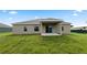 Tan house with covered patio and grassy backyard at 840 Voight N Ave, Fort Meade, FL 33841