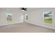 Well-lit bedroom featuring carpet flooring and multiple windows at 840 Voight N Ave, Fort Meade, FL 33841
