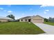 Tan house with a two-car garage and landscaping at 840 Voight N Ave, Fort Meade, FL 33841