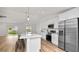 Modern kitchen with white cabinets, stainless steel appliances, and an island at 840 Voight N Ave, Fort Meade, FL 33841