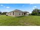 Tan house with covered patio and grassy backyard at 840 Voight N Ave, Fort Meade, FL 33841