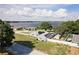 Aerial view of a waterfront home with a large yard and solar panels at 152 Audubon Ct, Winter Haven, FL 33884