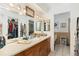 Bathroom with double vanity, large mirror, and access to walk-in closet at 152 Audubon Ct, Winter Haven, FL 33884