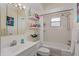 Clean bathroom with shower/tub combo, updated vanity, and floating shelves at 152 Audubon Ct, Winter Haven, FL 33884