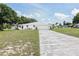 White brick home with a long driveway and grassy yard at 152 Audubon Ct, Winter Haven, FL 33884