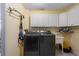 Laundry room with washer, dryer, cabinets, and utility sink at 152 Audubon Ct, Winter Haven, FL 33884