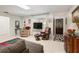 Bright living room with large TV, comfortable seating, and access to a sunroom at 152 Audubon Ct, Winter Haven, FL 33884