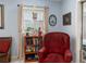 Cozy sitting area with comfortable armchair and home library at 152 Audubon Ct, Winter Haven, FL 33884