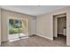Bright bedroom with wood-look floors and sliding glass door to patio at 1033 Lakewood Ct, Lakeland, FL 33801