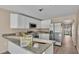 Modern kitchen with white cabinets, granite counters, and stainless steel appliances at 1033 Lakewood Ct, Lakeland, FL 33801