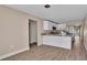 Open concept kitchen with white cabinets and granite countertops at 1033 Lakewood Ct, Lakeland, FL 33801