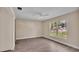 Spacious bedroom featuring wood-look floors and a ceiling fan at 1033 Lakewood Ct, Lakeland, FL 33801