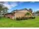 Side view of brick house with landscaping and palm trees at 6107 Christina W Dr, Lakeland, FL 33813