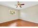 Spacious bedroom with wood-look floors, a window, and ceiling fan at 6107 Christina W Dr, Lakeland, FL 33813