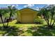 Detached garage with yellow exterior and a large overhead door at 431 Longfellow Blvd, Lakeland, FL 33801