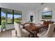 Elegant dining room features a large table, hardwood floors, and a view of the water at 1969 Grasslands Blvd, Lakeland, FL 33803