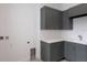 Laundry room with gray cabinets and white countertops at 1969 Grasslands Blvd, Lakeland, FL 33803