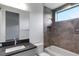 Modern bathroom with gray tile shower and bathtub at 1969 Grasslands Blvd, Lakeland, FL 33803