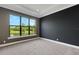 Bright bedroom with dark accent wall and a large window overlooking the water at 1969 Grasslands Blvd, Lakeland, FL 33803