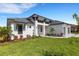 Modern two-story house with a landscaped yard at 1969 Grasslands Blvd, Lakeland, FL 33803