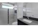 Clean bathroom with a single sink, shower, and neutral tile at 1969 Grasslands Blvd, Lakeland, FL 33803