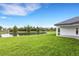 Waterfront property with covered patio and lush lawn at 1969 Grasslands Blvd, Lakeland, FL 33803