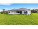 Home showcasing a covered patio and large backyard at 1969 Grasslands Blvd, Lakeland, FL 33803