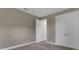 Simple bedroom with neutral walls and carpeting, and double door closet at 1969 Grasslands Blvd, Lakeland, FL 33803