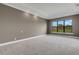 Spacious bedroom with neutral walls and carpeting, plus a large window at 1969 Grasslands Blvd, Lakeland, FL 33803