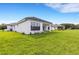 House with covered patio and expansive grassy backyard at 1969 Grasslands Blvd, Lakeland, FL 33803