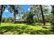 Spacious home nestled on a lush green lawn, surrounded by tall trees at 7520 Kathleen Rd, Lakeland, FL 33810