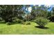 Spacious backyard with lush landscaping and mature trees at 7520 Kathleen Rd, Lakeland, FL 33810