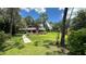 Large backyard with lush grass and mature trees at 7520 Kathleen Rd, Lakeland, FL 33810