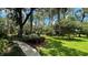 A winding sidewalk leads through a beautifully landscaped yard at 7520 Kathleen Rd, Lakeland, FL 33810