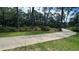 Concrete sidewalk winding through a tree-lined landscape at 7520 Kathleen Rd, Lakeland, FL 33810