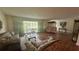 Living room with hardwood floors, large windows, and comfortable furniture at 7520 Kathleen Rd, Lakeland, FL 33810
