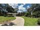 Brick home with a circular driveway and lush landscaping at 7520 Kathleen Rd, Lakeland, FL 33810
