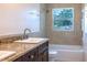 Updated bathroom with double vanity, granite countertop and tile shower at 2508 Providence Rd, Lakeland, FL 33805
